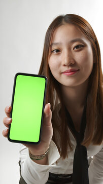 Young Asian Woman Showing Smartphone with Green Screen Mockup