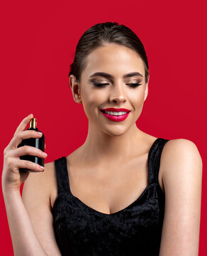 Perfume bottle woman spray aroma. Girl holds cosmetics, serum in a vial. Woman spraying luxury perfume