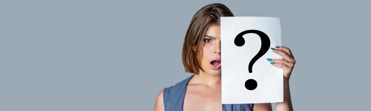 Question. Woman holding a placard with question mark symbol, thinking. Woman with doubtful expression and question marks