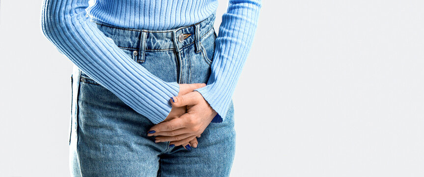Sick woman hands holding pressing her crotch lower abdomen