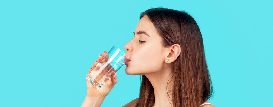 Happy woman drinking water. Woman drinking from a glass of water. Health care concept photo, lifestyle