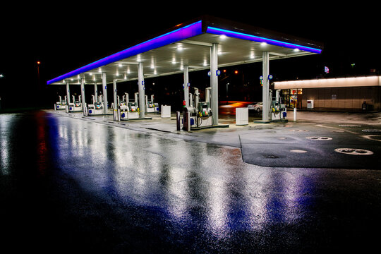Gas station with fuel pumps lit at night in Tacoma, WA, USA