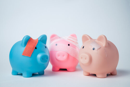 Piggy bank wrapped in a bandage on a plain background with copy space, representing financial recovery, debt relief, deposit protection, bankruptcy, business rehabilitation and a fresh start.