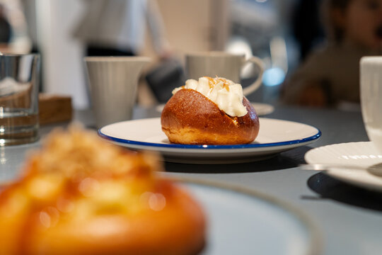 Sweet cream bun dessert on table with blurry background cafe