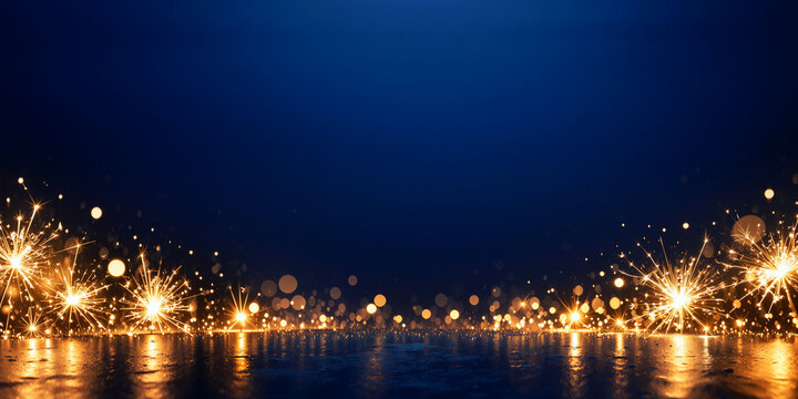 Sparkling firework embers glowing against a deep dark blue night sky