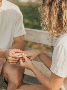 Man Putting Engagement Ring on Woman Finger During Romantic Marriage Proposal