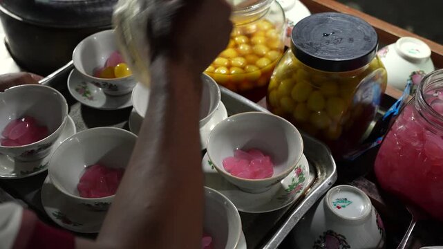 preparing Wedang Ronde, a warm Javanese ginger dessert soup with glutinous rice balls in vintage ceramic bowls.