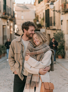 Romantic Young Couple Embracing Warmly in Scarf on Old European City Street