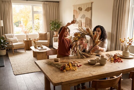 Family making an autumn wreath together at the table