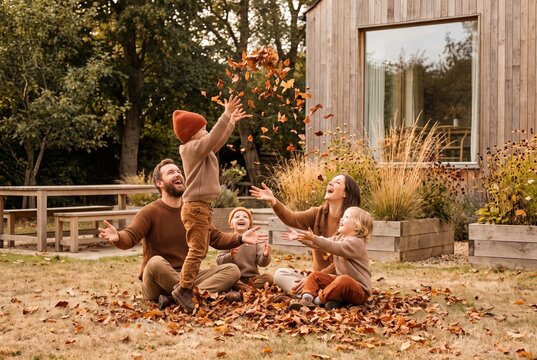 Family playing in the autumn garden at home