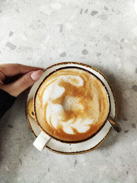 Latte Art Coffee Cup on White Marble Table Top View Background