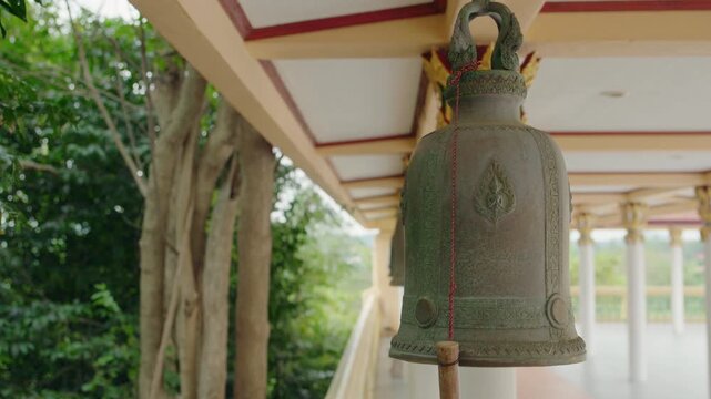 Ornate Bronze Bell Hanging Beneath Covered Structure