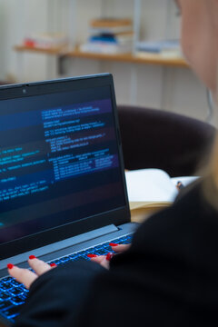 Programmer or IT pointing to code cybersecurity on laptop at home office for concept verifying code algorithm. Employees woman write code, typing on computer for software development. Remote work.