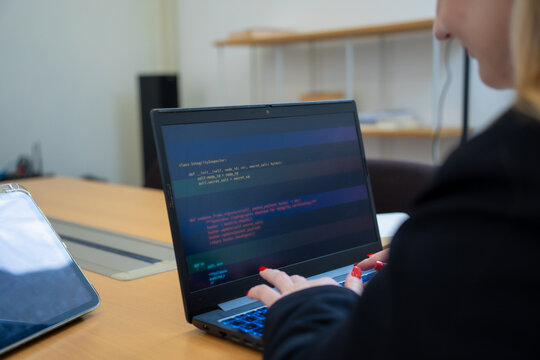 Programmer or IT pointing to code cybersecurity on laptop at home office for concept verifying code algorithm. Employees woman write code, typing on computer for software development. Remote work.