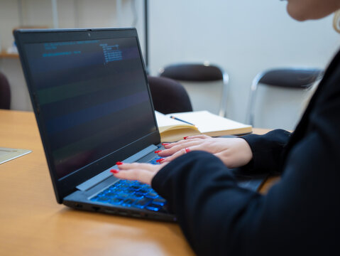 Programmer or IT pointing to code cybersecurity on laptop at home office for concept verifying code algorithm. Employees woman write code, typing on computer for software development. Remote work.