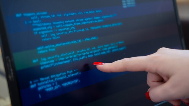 Programmer or IT pointing to code cybersecurity on laptop at home office for concept verifying code algorithm. Employees woman write code, typing on computer for software development. Remote work.