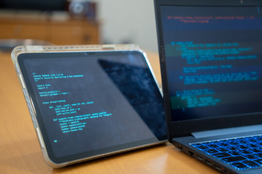 Programmer or IT pointing to code cybersecurity on laptop at home office for concept verifying code algorithm. Employees woman write code, typing on computer for software development. Remote work.