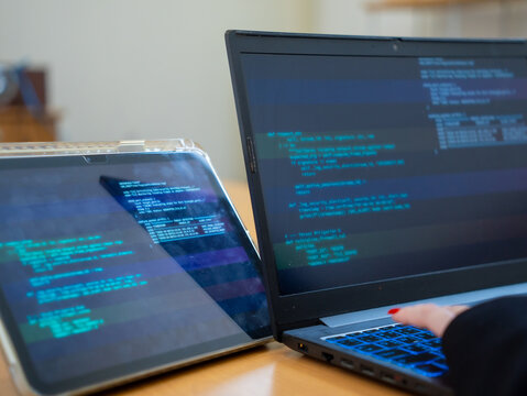 Programmer or IT pointing to code cybersecurity on laptop at home office for concept verifying code algorithm. Employees woman write code, typing on computer for software development. Remote work.