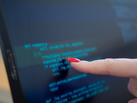Programmer or IT pointing to code cybersecurity on laptop at home office for concept verifying code algorithm. Employees woman write code, typing on computer for software development. Remote work.