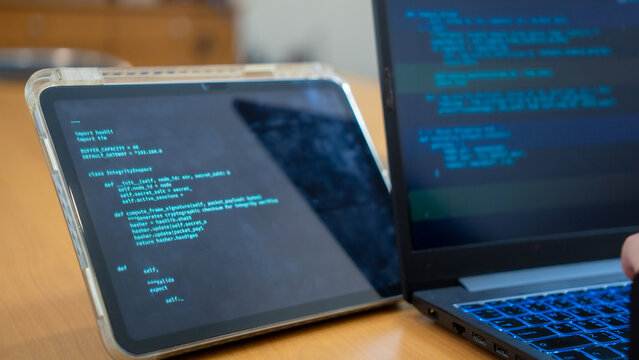 Programmer or IT pointing to code cybersecurity on laptop at home office for concept verifying code algorithm. Employees woman write code, typing on computer for software development. Remote work.