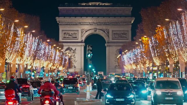 Christmas street decoration. Building, trees in garlands. Paris France. Christmas light illuminated at night during the Christmas season in centre Paris. Crow of people