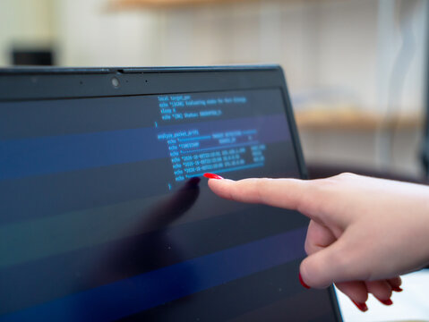 Programmer or IT pointing to code cybersecurity on laptop at home office for concept verifying code algorithm. Employees woman write code, typing on computer for software development. Remote work.