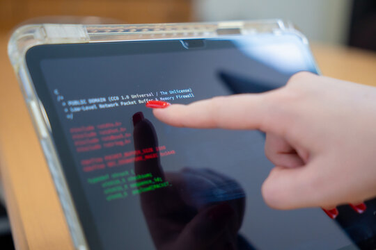 Programmer or IT pointing to code cybersecurity on laptop at home office for concept verifying code algorithm. Employees woman write code, typing on computer for software development. Remote work.