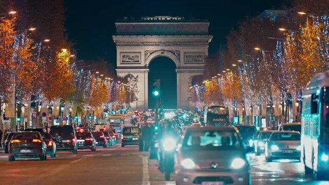 Christmas street decoration. Building, trees in garlands. Paris France. Christmas light illuminated at night during the Christmas season in centre Paris. Crow of people