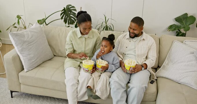 Laugh, popcorn and black family on sofa with watching tv, funny show and movie binge on weekend. Above, parents and happy girl on couch with snack, quality time and entertainment streaming in home.
