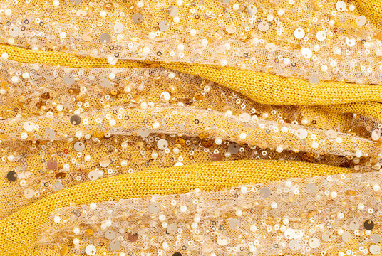 Gold sequin fabric with yellow knit folds and shimmer