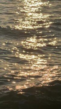 Nature background with sea waves in golden hour in the evening. Summer vacation season.