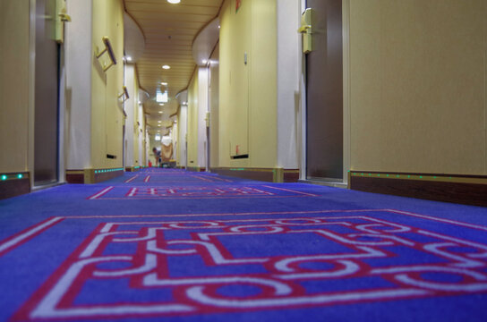 Corridor or aisle to cabins, staterooms or suites on modern luxury Norwegian cruise ship or cruiseship liner interior	