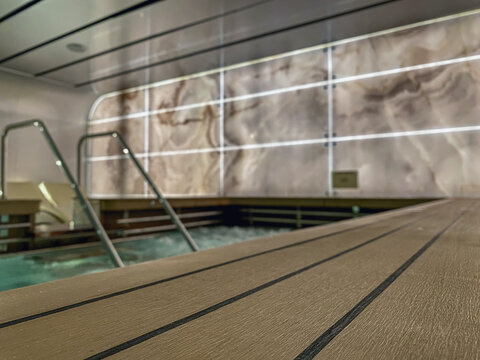 Indoor swimmingpool with hot tub whirlpool inside thermal suite in spa or wellness area onboard luxury modern cruiseship or cruise ship liner for beauty and balance