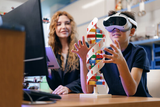 Boy wearing virtual reality headset exploring dna model classroom, AI intelligence technology for children in school