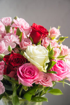 Mixed pink, red and white roses with carnations in a lush floral bouquet