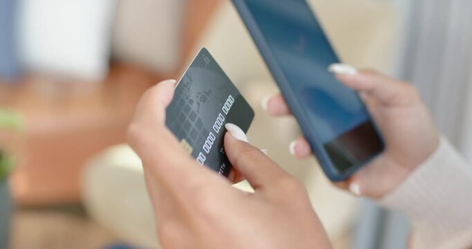 Left hand is tapping card numbers in living room, phone is verifying payment and showing checkmark