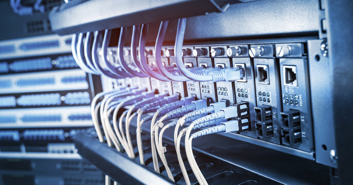 Fiber Optic cables connected to optic ports and UTP, Network cables connected to ethernet ports.