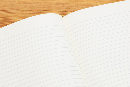 Blank lined notepad on a wood desk
