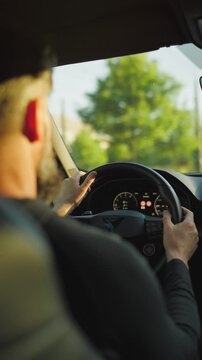 Man driving car through the streets of the city.