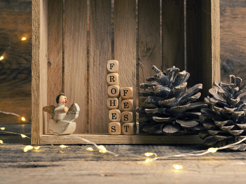 Small wooden block with the German words Frohes Fest and Christmas decoration