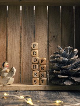 Small wooden block with the German words Frohes Fest and Christmas decoration