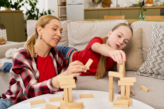 Mother and daughter enjoy a delightful building game at home together
