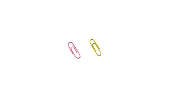 Pink and yellow paper clips isolated on white background