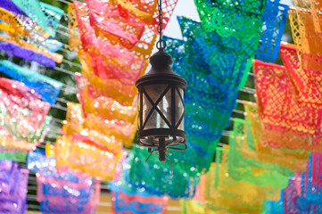 Decorative hanging lantern surrounded by colorful Mexican papel picado decorations,  Jalisco, Mexico © TOimages