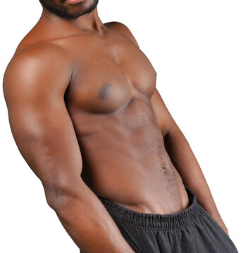 Shirtless man posing against a white studio background during a portrait session