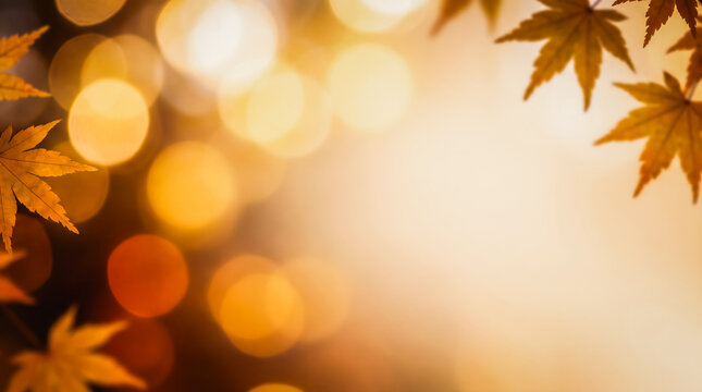 Soft, golden bokeh light in shades of gold, amber, and deep orange, accented by maple leaves in the corners an abstract, warm-toned autumn background that offers ample space for text or other elements