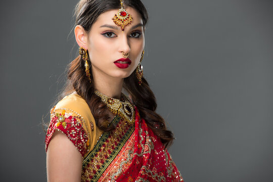 Young Indian woman celebrates Diwali in elegant saree and beautiful jewelry