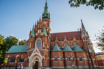 A side exterior view captures the grand scale and detailed brickwork of St. Joseph's Church, featuring its green copper roofs in Krakow, Poland. © Danica Chang