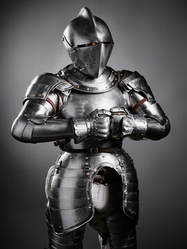 realistic portrayal of a medieval knight in shining plate armor, including detailed craftsmanship. An impressive reflection of historical military costumes, strength, and medieval warfare aesthetics.