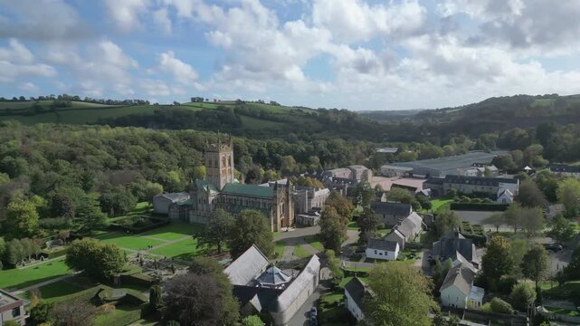 Buckfast, Devon, England: DRONE VIEWS: The village of Buckfast & Buckfast Abbey; in the background is Dartmoor National Park. The Abbey is run by Benedictine monks and produces its own wine.